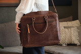 High quality lifestyle image of the women's business leather satchel in dark brown