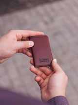 High quality lifestyle image of the slim business card leather holder in Italian reddish brown