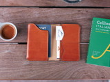 High quality open lifestyle image of the passport leather sleeve in light tan