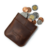 High quality dark brown leather coin purse that has change spilling out of the pouch.