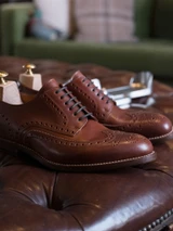 High quality wooden shoe trees inserted into a pair of brown leather wingtip shoes - Saddleback Leather