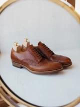 High quality red brown full grain leather wing tip shoes studio side profile view with wooden shoe trees - Saddleback Leather