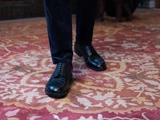 High quality black full grain leather wing tip shoes studio shown on a model - Saddleback Leather