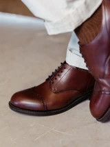 High quality close-up of dark oak full grain leather toe cap shoe brogue perforations and welt stitching - Saddleback Leather