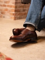 High quality overhead close-up of dark oak full grain leather toe cap shoe brogue detail and vamp - Saddleback Leather