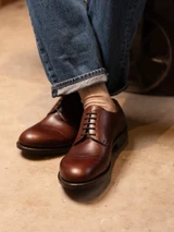 High quality overhead close-up of dark oak full grain leather toe cap shoe brogue detail and vamp - Saddleback Leather