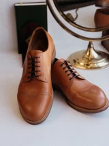 High quality tan full grain leather toe cap shoes front view showing perforated brogue toe cap detail - Saddleback Leather
