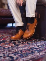 High quality tan full grain leather toe cap shoes side profile lifestyle shot on patterned rug - Saddleback Leather