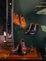 High quality full grain leather toe cap shoes collection display in three colorways on stands with vanity mirror - Saddleback Leather