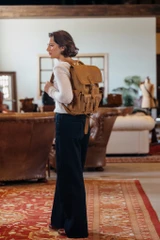 High quality front pocket backpack in light brown on a woman