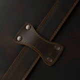 High quality leather trunk that will be a vintage antique one day in a museum. This is the leather pass through for the strap. It is a dark brown steamer trunk that was old time luggage back in the day on trains and ships.