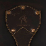 High quality leather trunk that will be a vintage antique one day in a museum. This is the family crest of the brand. It is a dark brown steamer trunk that was old time luggage back in the day on trains and ships.