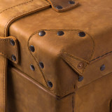 High quality leather trunk that will be a vintage antique one day in a museum. This is the corner. It is a tan brown steamer trunk that was old time luggage back in the day on trains and ships.