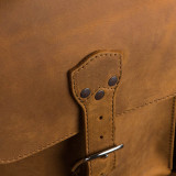 High quality leather trunk that will be a vintage antique one day in a museum. This is the strap and where it closes on it.. It is a tan brown steamer trunk that was old time luggage back in the day on trains and ships.