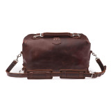 High quality red brown leather duffle bag with three straps on the front but not showing. This overnight bag has no straps on the back.