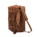High quality tan brown leather duffle bag with the shoulder strap that is used as backpack straps.