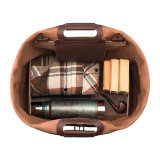 High quality this tan brown leather duffle bag is open and it shows that it holds a whole lot of stuff.