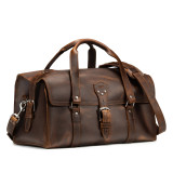 High quality dark brown leather duffle bag that has three straps to close it and has two round handles from the front side.