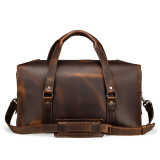 High quality dark brown leather duffle bag that has three straps to close it and has two round handles from the back side.