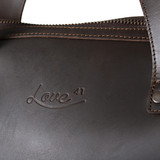 High quality up close look at the logo in dark coffee
