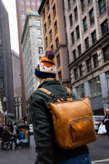 High quality this tan leather woman's backpack is shown on a model