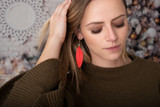 High quality model images of the red leather feather earrings