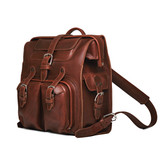 High quality side view of the red brown big mouth leather backpack that has a gladstone closure for easy access to your things. Made by Saddleback