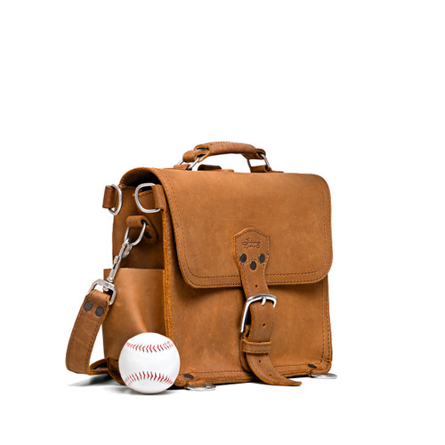 This is the front view of a tan brown rounded leather satchel.