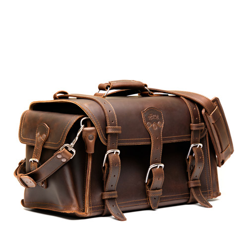 High quality dark brown side pocket duffle from the front. Made from full grain leather (toughest there is) and reinforced with rivets on any stress points. Made by Saddleback Leather