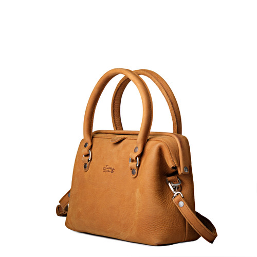 This full-grain leather purse is angled to show the removable strap.