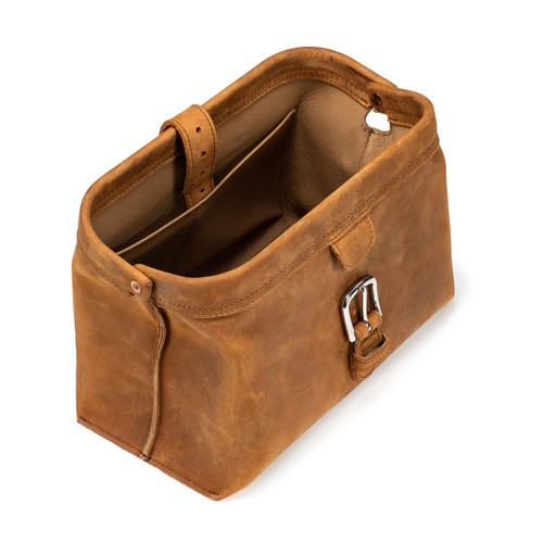 This is a tan brown leather toiletry bag on the top side.
