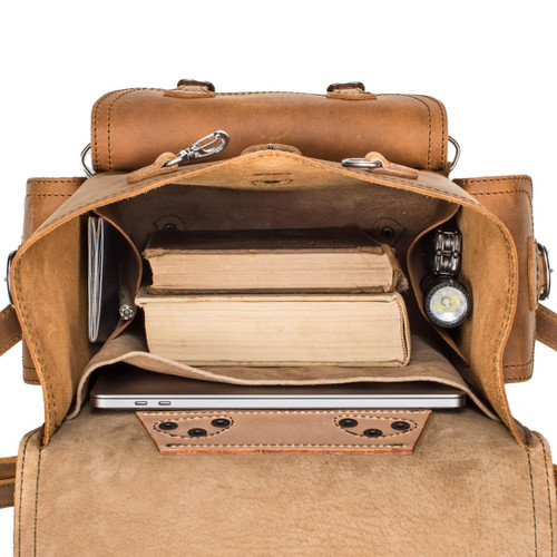 High quality the inside of this tan brown leather backpack is lined with lighter tan pigskin leather