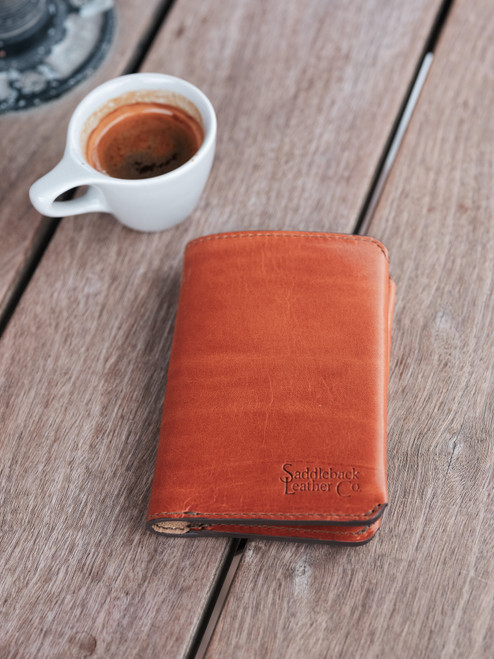 High quality closed lifestyle image of the passport leather sleeve in tan