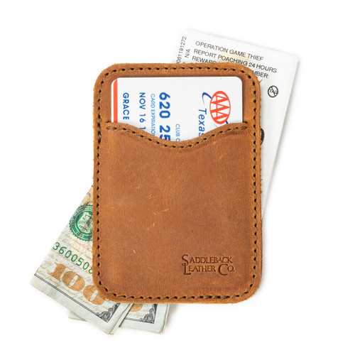 High quality tan brown leather wallet open with cash sticking out both ends.