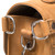 This is the side view of hardware on a tan brown rounded leather satchel.