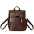 High quality front view of the leather all in one backpack in red brown showing a device in the pocket