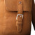High quality 16 inch leather drawstring backpack in tan close up view of the pocket
