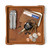 High quality tan colored leather valet tray holding a wallet, keys, change, and pocket knife, made by Saddleback