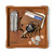 High quality tan colored leather valet tray with a wallet, keys, change, and pocket knife in it. Made by Saddleback