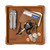 High quality tan colored leather valet tray with a wallet, keys, change, and pocket knife on it. Made by Saddleback