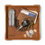 High quality tan colored leather valet tray with a wallet, keys, change, and a pocket knife on it. Made by Saddleback