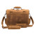 This is the back pf the tan full grain leather briefcase with the shoulder strap laying down in front of it.