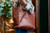High quality model image of our red brown conceal carry leather tote