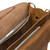 High quality close up of the tan brown leather briefcase open with a laptop inside.