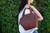 High quality lifestyle image of the red brown colored Dovetail leather Satchel