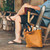 High quality tan brown women's leather tote that some women use as a purse. It is facing the side.