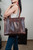 The Women's work tote in dark coffee brown showing a model view