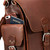 High quality side pocket behind the pocket of a red brown leather backpack.