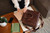 High quality lifestyle image of the women's business leather satchel in dark brown