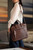 This is the lifestyle image of the women's business satchel in dark brown
